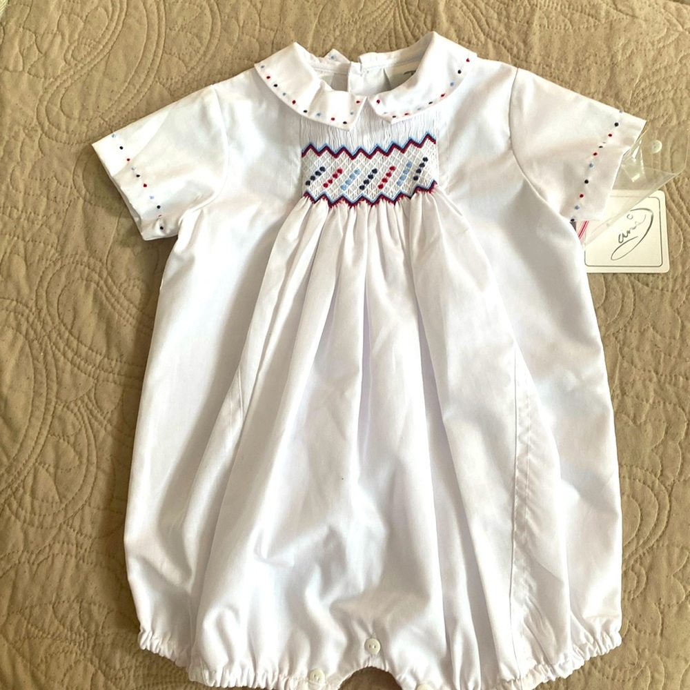 Dani 6M smocked outfit. White with red & blue details.